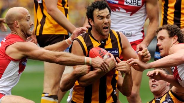 In possession: Hawthorn's Jordan Lewis is besieged from all sides.