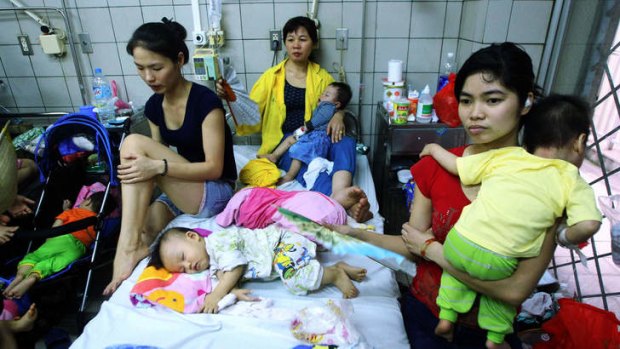Families with children suffering from measles at a hospital in Hanoi.