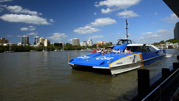 A CityCat docks on the Brisbane River.