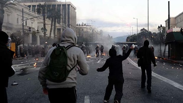 Making their point ... protesters clash with riot police in front of the Greek Parliament in Athens.