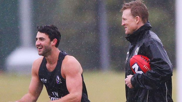 Nathan Buckley oversees the recovery of Alex Fasolo during pre-season training.