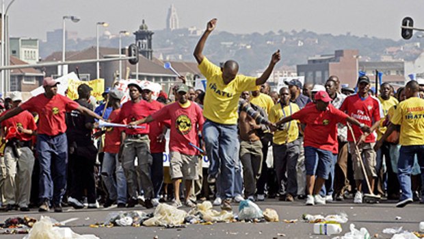Snowballing ... protesters empty rubbish bins in the streets as the march on Durban’s city hall.