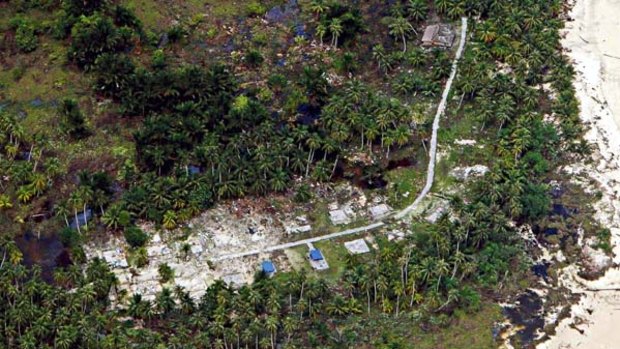 An aerial view shows a devastated village two days after a tsunami hit the island of Siporapora, part of the Mentawai islands, West Sumatra, Indonesia
