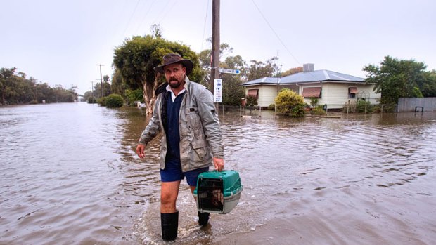 Leighton Murdoch helps his mate Glen Viney save the family cats.