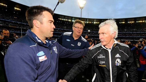 Geelong coach Chris Scott shakes hands with his counterpart, Collingwood's Mick Malthouse.