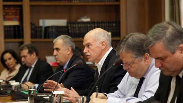 Time is running out ... Greek PM George Papandreou addresses his ministers during a cabinet meeting on Tuesday.