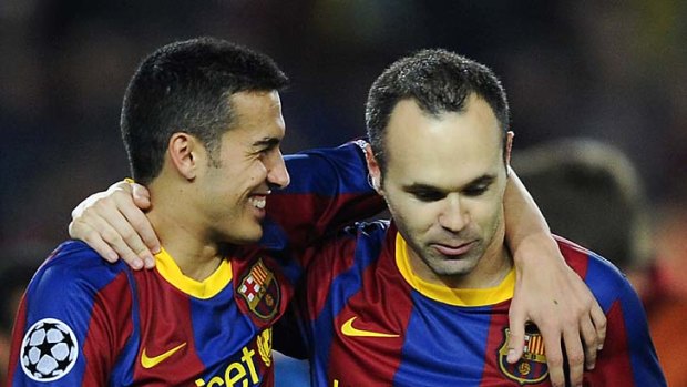 Through to the final ... Pedro celebrates with Andres Iniesta.