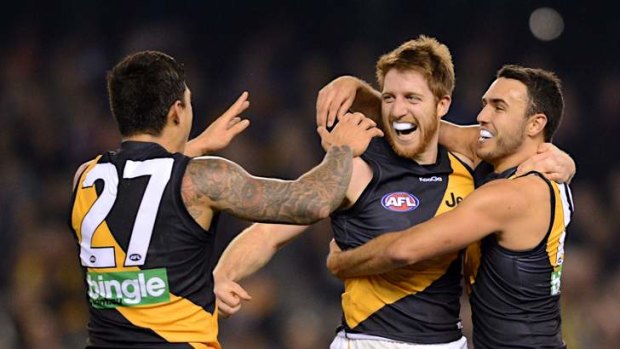 Fighting fit: Richmond's Reece Conca (centre) celebrates a goal with Aaron Edwards (left) and Shane Edwards.