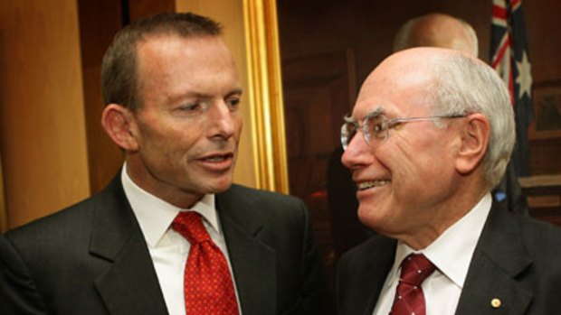 Present Liberal leader and former ... Tony Abbott and John Howard at Parliament House yesterday.
