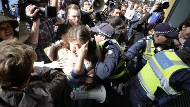 Students and police clash outside the Melbourne University building.