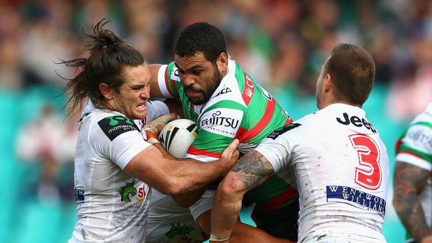 'He's being used as a battering ram': Greg Inglis is tackled by the Dragons defence.