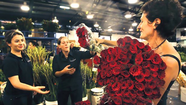 Love through rose-coloured glasses ... Parthenie Lalas, left, and Sarah Malone, centre, help their boss Tanya Waterhouse buy roses at the Flemington flower market.