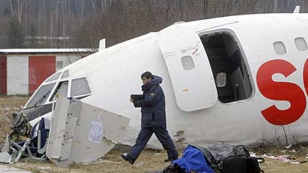An investigator examines the wreckage of the Dagestan Airlines Tupolev Tu-154 passenger jet.