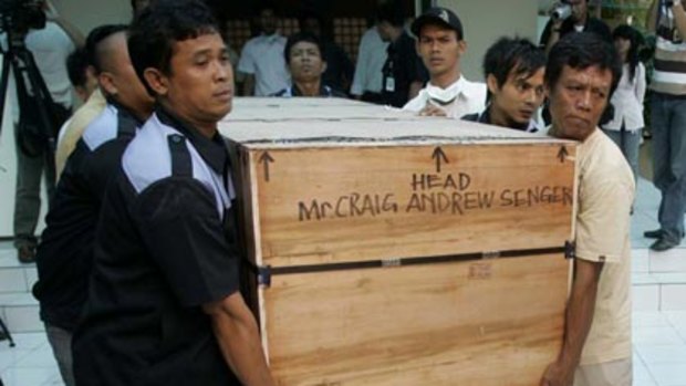 Final journey ... hospital workers carry a crate containing the coffin of Australian Craig Senger, a victim of Jakarta's double hotel bombing.