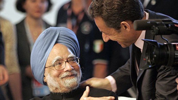 Welcome to the club ... Nicolas Sarkozy of France greets India's Prime Minister, Manmohan Singh, at the G8 summit.