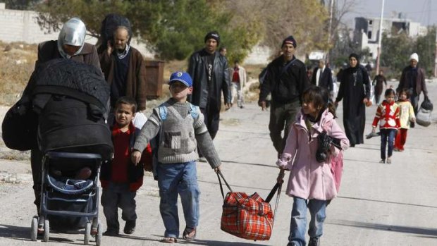 Some relief: Syrian families leave the Damascus suburb of Moadamiya during the ceasefire.