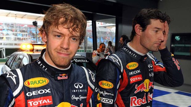 Sebastian Vettel smiles after securing pole position while teammate Mark Webber sports a more sober expression after securing the third spot on the grid.