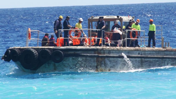 A boat intercepted earlier this month with 85 asylum seekers on board is taken to Christmas Island.