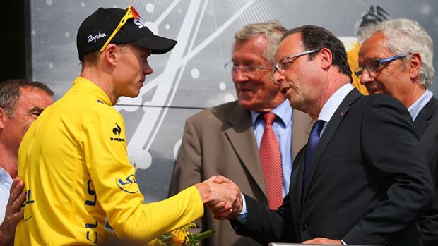 Race leader Chris Froome shakes hands with French President Francois Hollande after stage nine on Sunday.