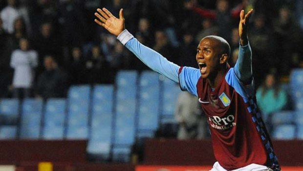 Knocked out ... Aston Villa's Ashley Young protests to the referee during the match.