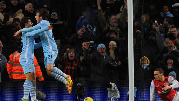 Manchester City's Spanish midfielder David Silva (second from left) celebrates with Sergio Aguero after scoring against Arsenal.