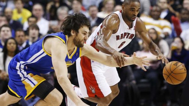 Raptorus reception ... Andrew Bogut vies for the ball with Toronto's Alan Anderson in his NBA comeback game on Monday.