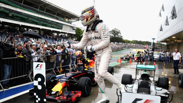 Title race still alive: Lewis Hamilton celebrates winning in Brazil.