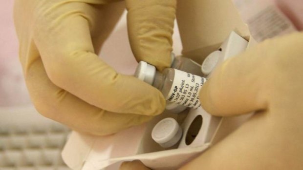 Scientists at the National Microbiology Lab in Winnipeg, Canada, prepare an experimental Ebola vaccine for shipment to the World Health Organisation in Geneva.