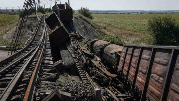 Train wagons on a destroyed railway bridge which collapsed during the fighting between the Ukrainian army and pro-Russian separatists.