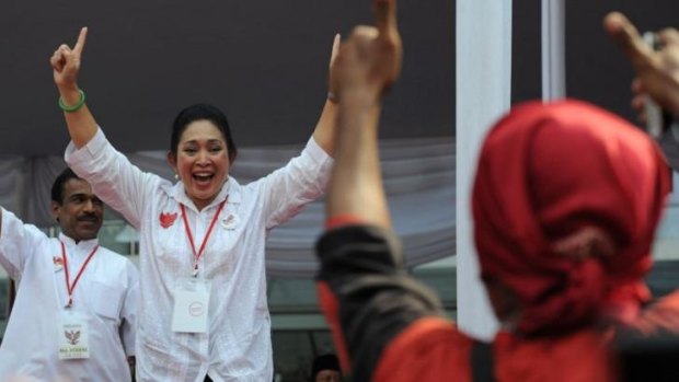 Siti Hediati Harijadi, known as Titiek, daughter of late Indonesian dictator Suharto and ex-wife of presidential candidate Prabowo Subianto greets the crowd during a rally for Subianto in Jakarta in June.