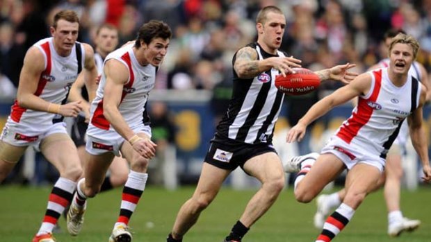 The prolific Dane Swan leaves a pack of chasing Saints for dead.