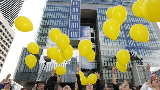 Family and supporters of Allison Baden-Clay release balloons outside court.