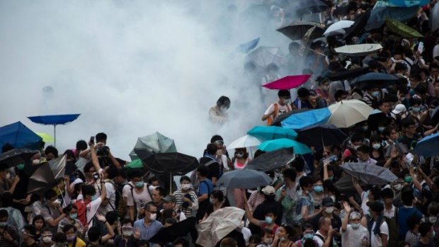 Police fire tear-gas at demonstrators during a protest near central government offices in Hong Kong.