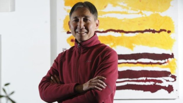Hou Leong with his painting <i>Red and Yellow Horizontal Lines.</i>