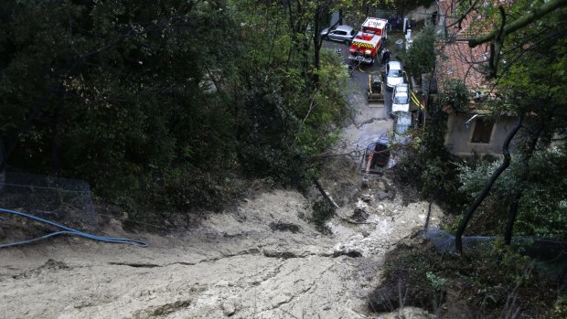 Cars are parked beneath a mudslide after heavy rains caused flooding in southeastern France.