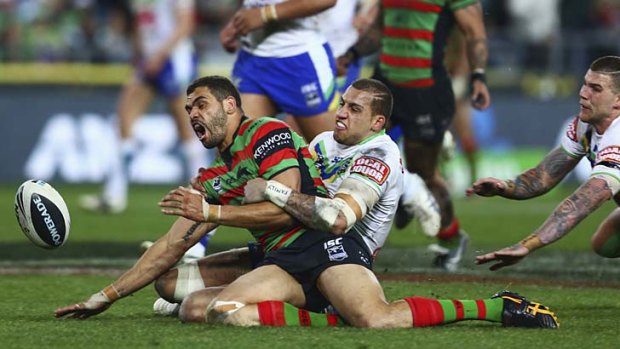 Armless: The Rabbitohs' Greg Inglis is tackled by the Raiders' Blake Ferguson.