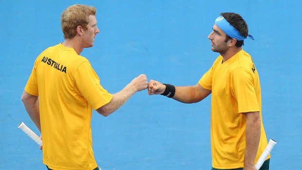 Australia's Chris Guccione (left) and Marinko Matosevic acknowledge a point in their Davis Cup doubles win over Suk-Young Jeong and Jae-Min Seol of South Korea in Brisbane.