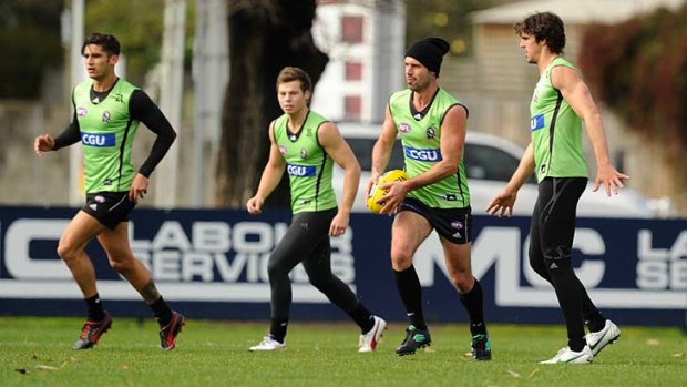 Back in town: Alan Didak (in beanie) yesterday. Didak returns from injury against the top-of-the-ladder Swans.