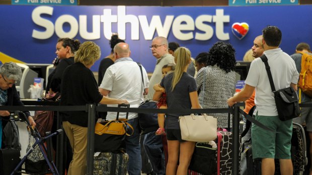 Passengers wait in line at the Southwest Airlines ticket counter Wednesday, Sept. 6, 2017 at Tampa International Airport. Many passengers were leaving Tampa on Wednesday ahead of Hurricane Irma which is threatening the Florida peninsula. (Chris Urso/Tampa Bay Times via AP)