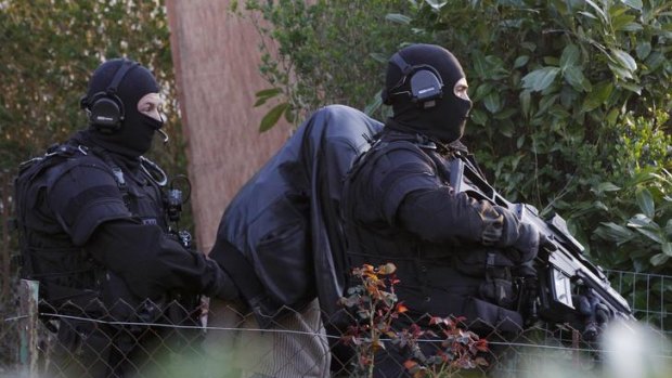 French special forces police make an arrest in Coueron, near Nantes as part of widespread raids.