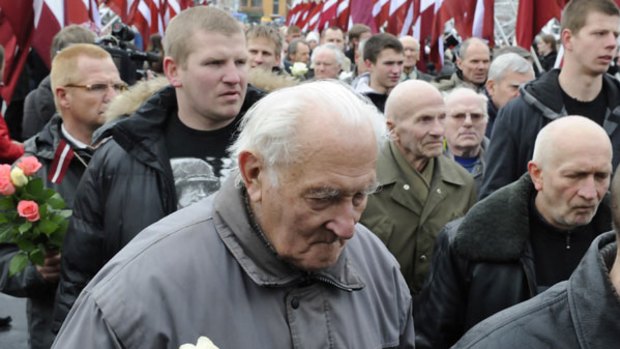 Latvians march to honour soldiers of the SS unit known as the Latvian Legion.