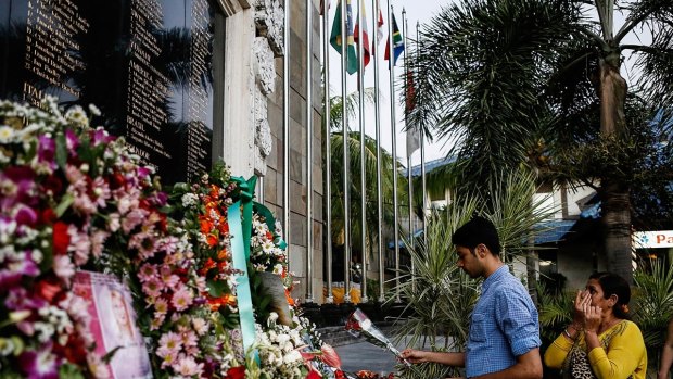 A man places flowers at the Bali Bombing Memorial Monument in Kuta, Bali, Indonesia in 2013.