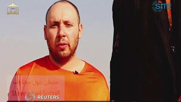This image from video posted on the internet by Islamic State militants purports to show journalist Steven Sotloff before he was beheaded.