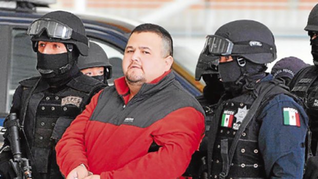 Drug lord Eduardo Teodoro Garcia Simental is escorted by police in Mexico City.