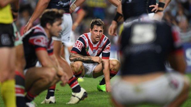Despair: Mitchell Pearce takes in defeat after a season that promised so much for the Roosters.