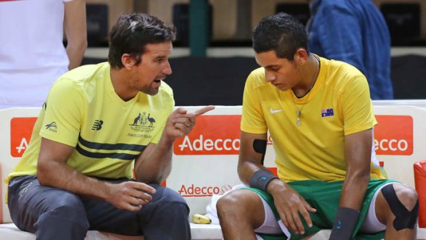 Looking for answers: Australia's Nick Kyrgios, right, listens to Australian team captain Patrick Rafter during his singles loss to France's Richard Gasquet.