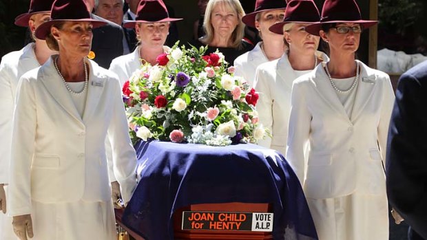 The coffin is carried from the service.