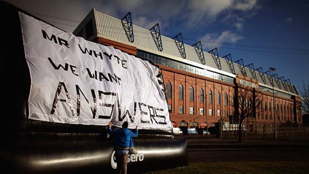 Why, oh why: Rangers fan Michael Haggerty makes his feelings known to owner Craig Whyte.