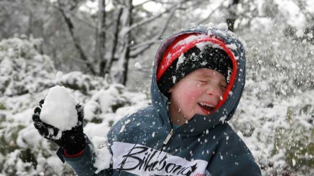 Patrick Gray, 4, has a ball on a snow-covered  Mount Macedon yesterday morning.