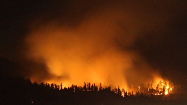 Smoke hangs above Highway 97 as a wildfire burns in Kelowna, British Columbia.